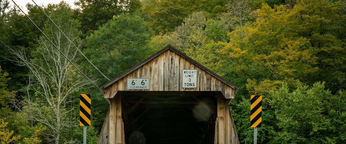 Roscoe, NY - USA - Sept 17, 2022 Horizontal view of the entrance to the Beaverkill Covered Bridge, also known as the Conklin Bridge, a wooden covered bridge over the Beaver Kill.