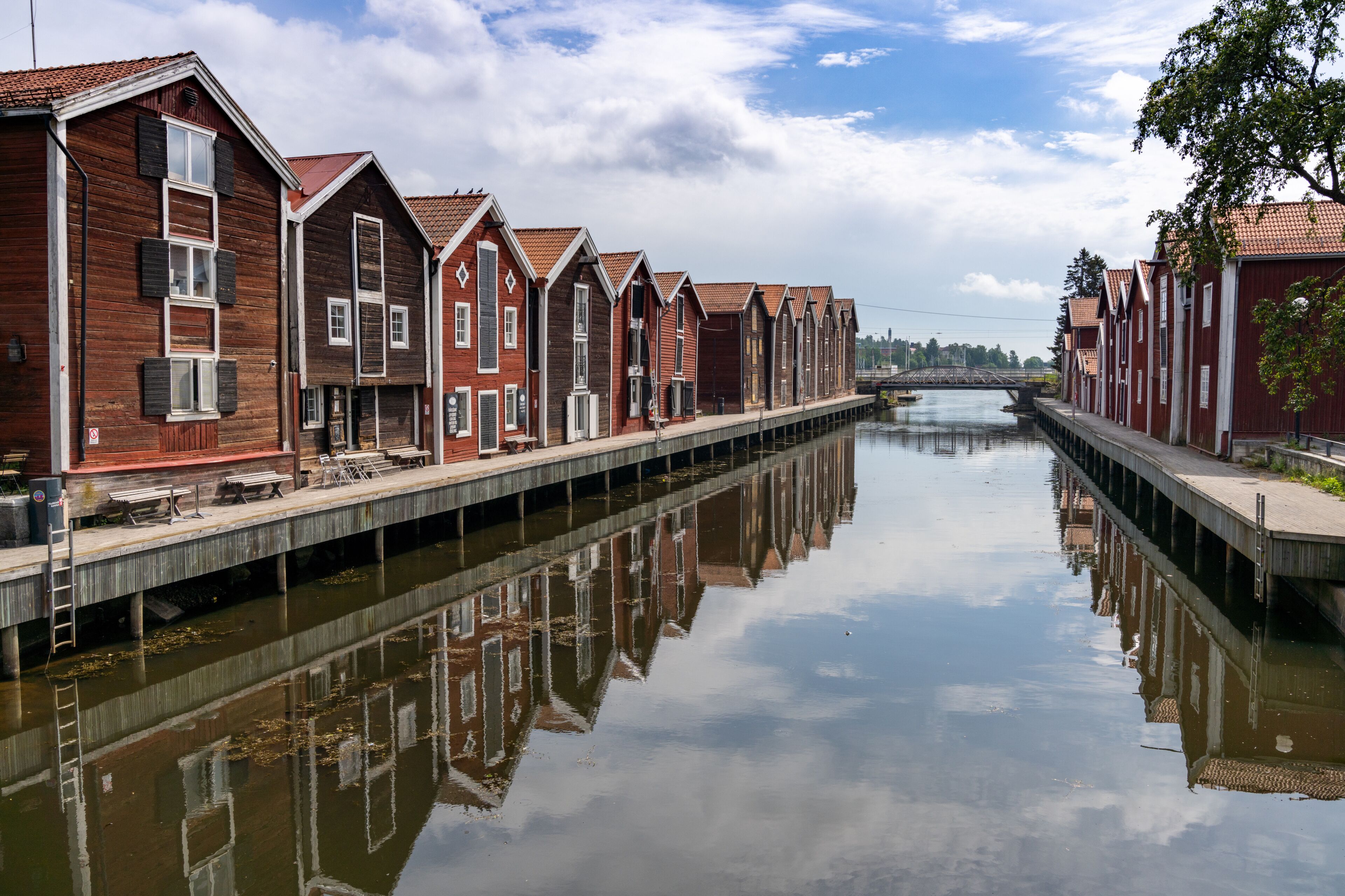red and brown wooden warehouses along the waterfront in Hudiksvall