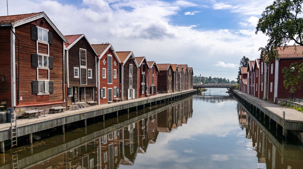 red and brown wooden warehouses along the waterfront in Hudiksvall