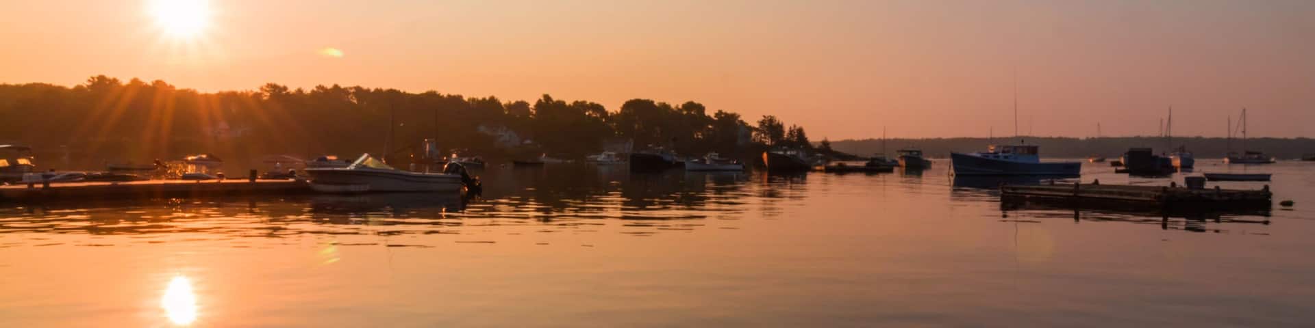 Round Pond Harbor, Maine, USA, boats in the harbor on a quiet still morning at sunrise in summer