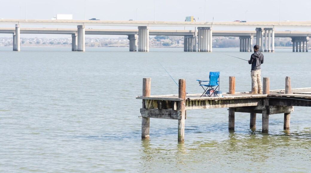 Unidentified fisherman fishing from pier jetty at Lake Ray Hubbard near Dallas, Texas, USA