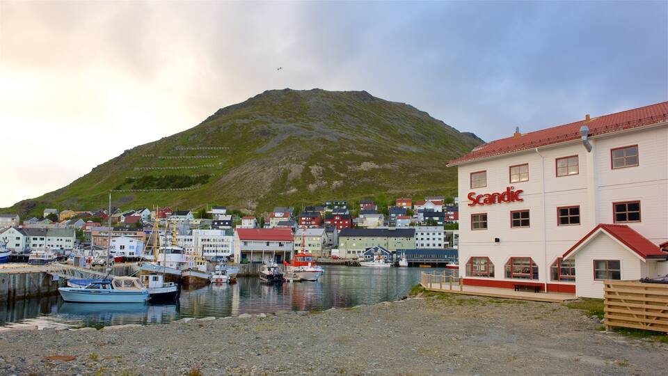 A harbor with boats, a building labeled "Scandic," and a mountain in the background.