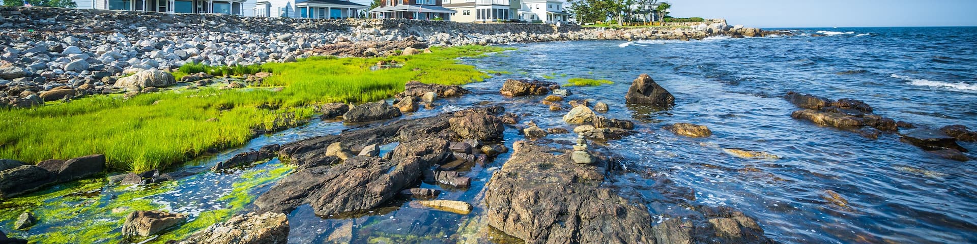 Rocky coast and beachfront homes at Concord Point, in Rye, New H