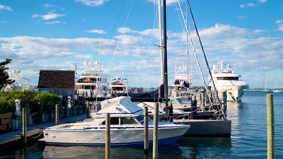 A marina with several yachts docked at wooden piers.