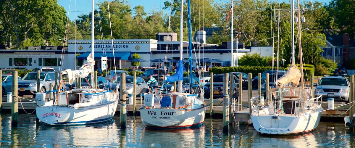 A marina with several boats docked, a community bandstand, and a restaurant named American Legion.