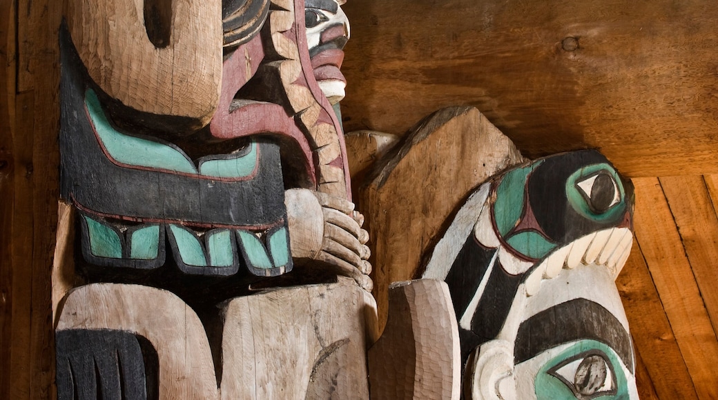 USA, Alaska, Kasaan. Close-up of human and animal figures on totem poles in Indian longhouse.