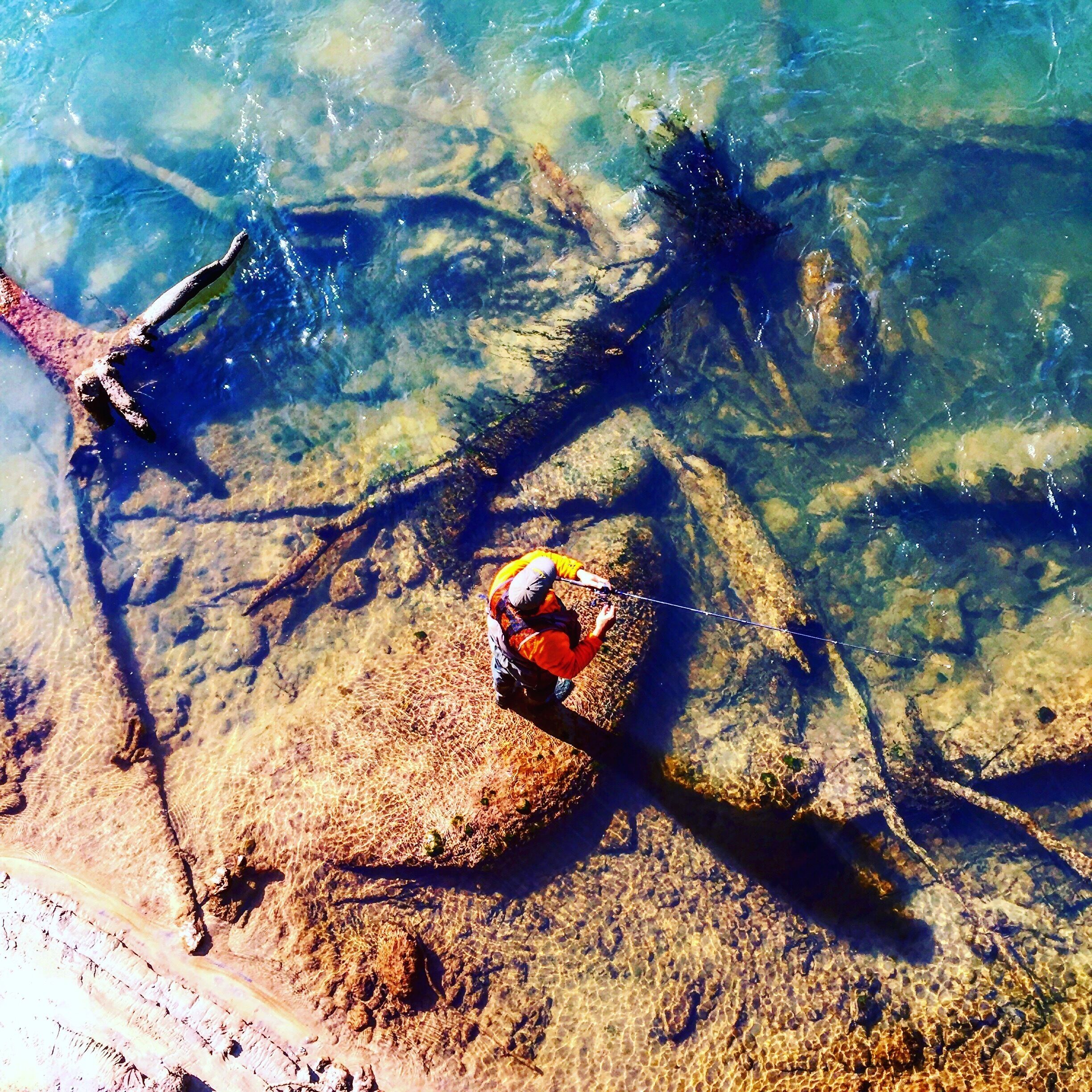 View from the bridge, man fishing