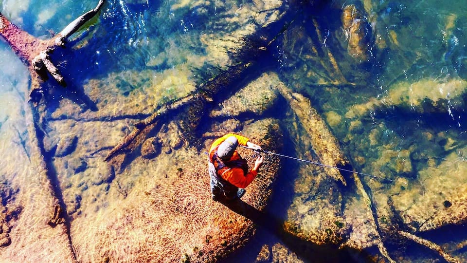 View from the bridge, man fishing