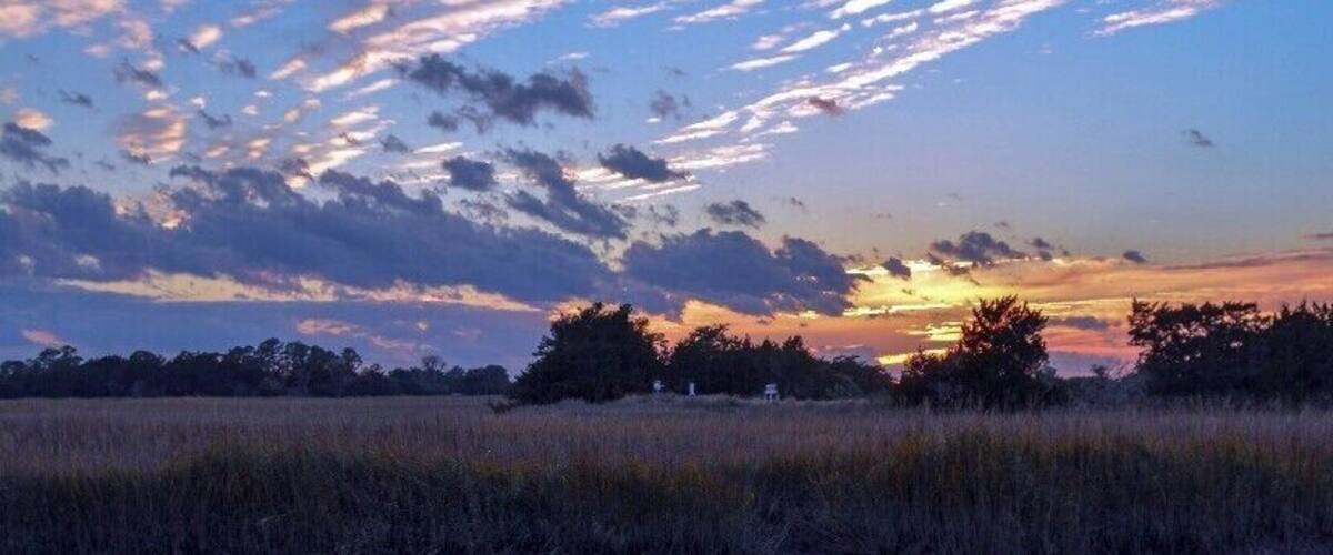 Sunset on Sapelo Island, Georgia. Of all of the east coast states of the U.S., Georgia has probably done the best job of preserving the character of its coastline. Several of the islands of the coast, such as Cumberland, St. Catherines, and Sapelo (pictured) aren't accessible by road or bridge, and mingle almost imperceptibly with the salt marshes around them. Sapelo is home to a University of Georgia research institute that was instrumental in the creation of the academic field of ecology.