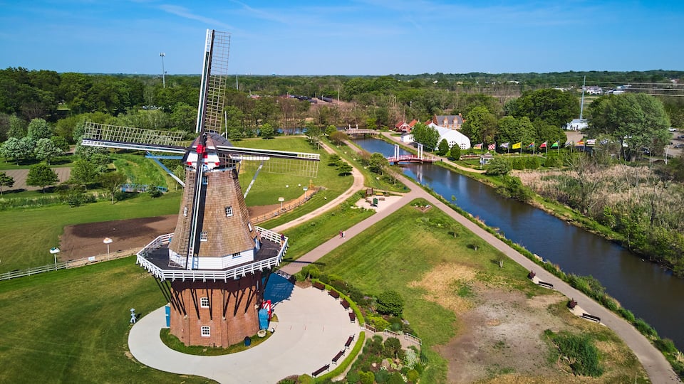 A windmill, a river, and a bridge.