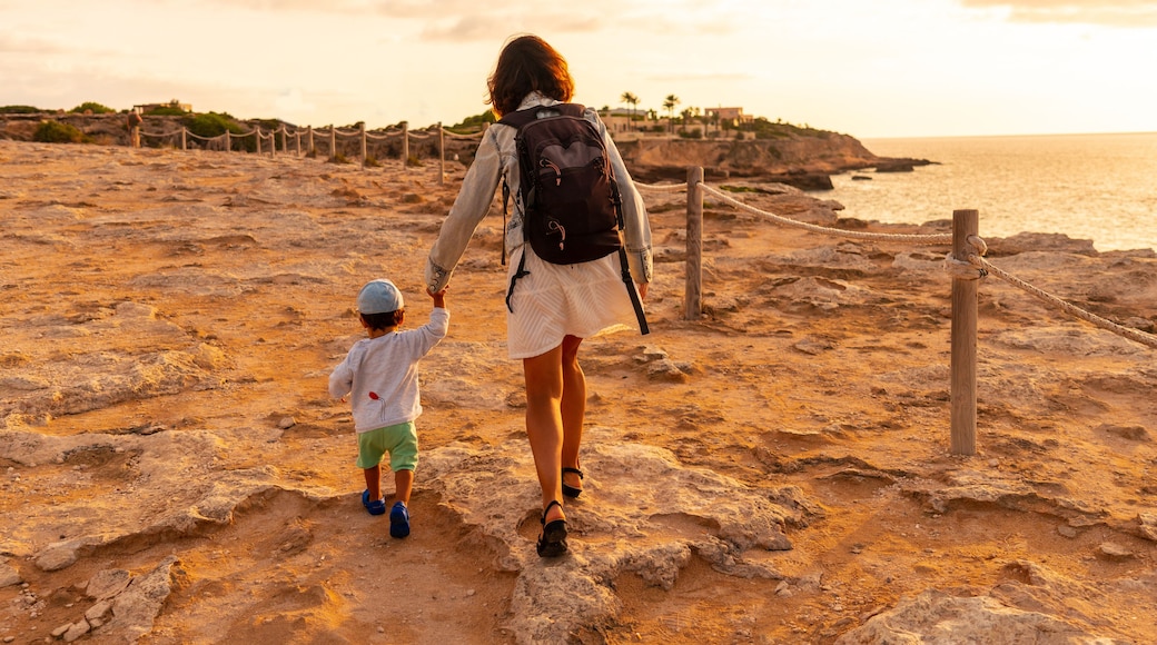 A mother with her son at sunset in Cala Comte beach on the island of Ibiza. Balearic