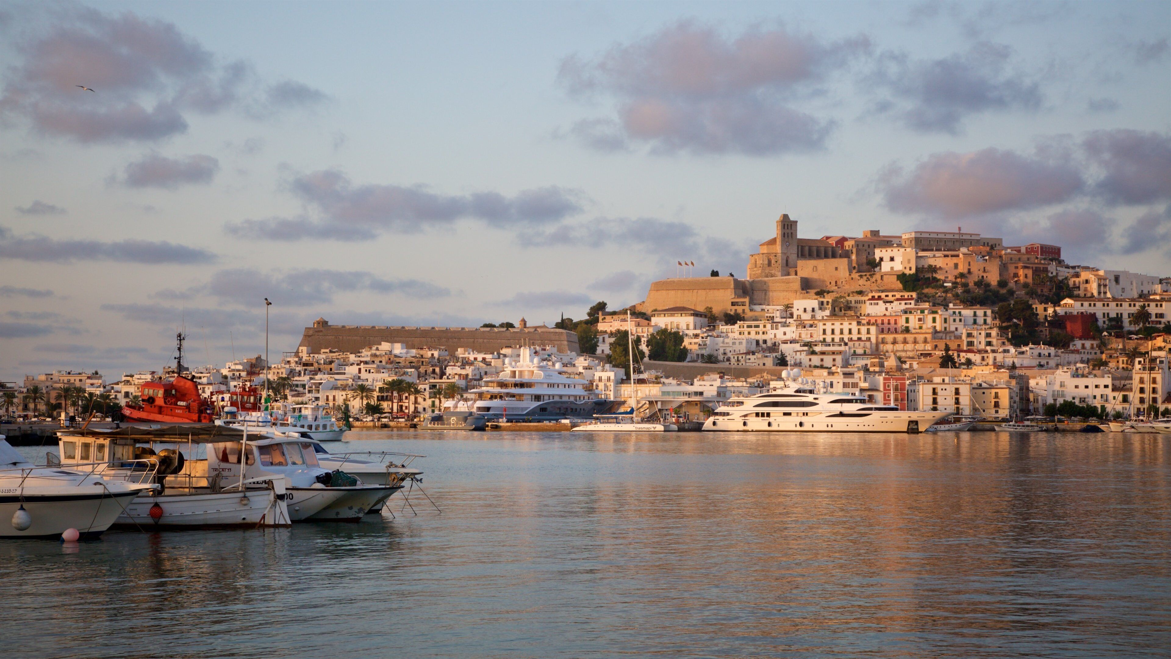 Ibiza which includes a bay or harbor, a coastal town and a sunset