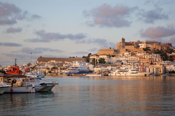 Ibiza which includes a bay or harbor, a coastal town and a sunset