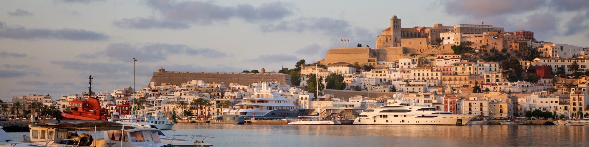 Ibiza which includes a bay or harbor, a coastal town and a sunset