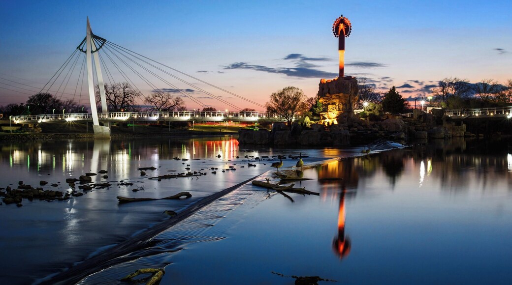 The Keeper of the Plains is a 44-foot tall steel sculpture standing at the point where the Big and Little Arkansas rivers join together in downtown Wichita. This land between the two rivers is sacred ground to the Native American people and is also home to the Mid-America All-Indian Center. The Indian Warrior sculpture was created by Wichitan and Native American artist Blackbear Bosin (1921-1980).
Come in time for the sunsets to enjoy the view along the eastern shore of the Arkansas River.
#Wichita #Kansas #Sunset #Reflections