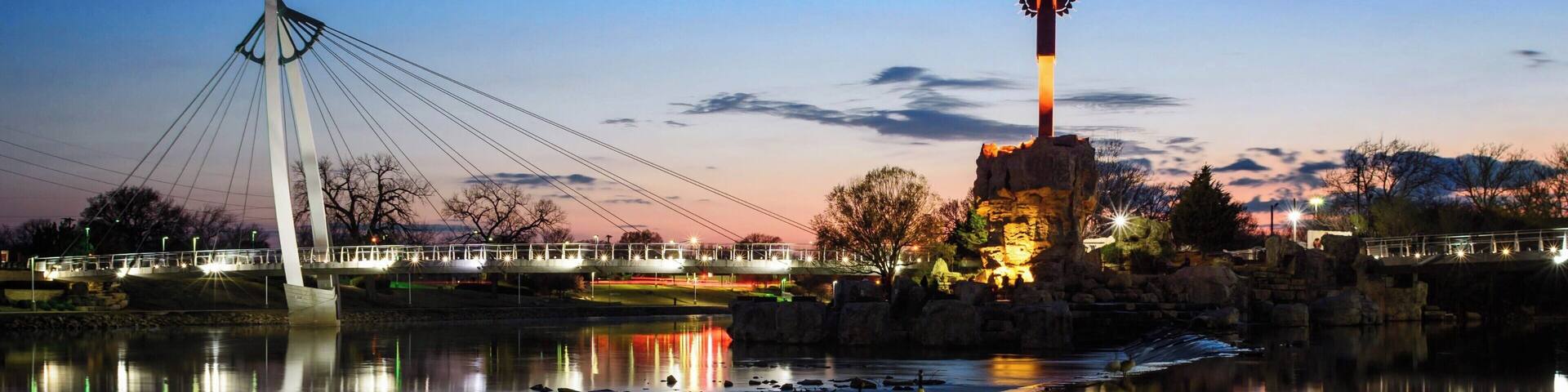 The Keeper of the Plains is a 44-foot tall steel sculpture standing at the point where the Big and Little Arkansas rivers join together in downtown Wichita. This land between the two rivers is sacred ground to the Native American people and is also home to the Mid-America All-Indian Center. The Indian Warrior sculpture was created by Wichitan and Native American artist Blackbear Bosin (1921-1980).
Come in time for the sunsets to enjoy the view along the eastern shore of the Arkansas River.
#Wichita #Kansas #Sunset #Reflections