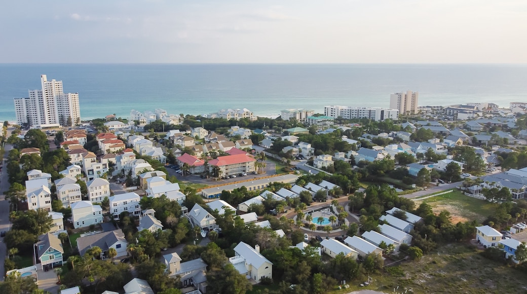 White three-story vacations homes, condo buildings surrounding by lush green trees in beach neighborhood along county road 30A, Gulf shoreline and Emerald Coast Santa Rosa, Florida, USA