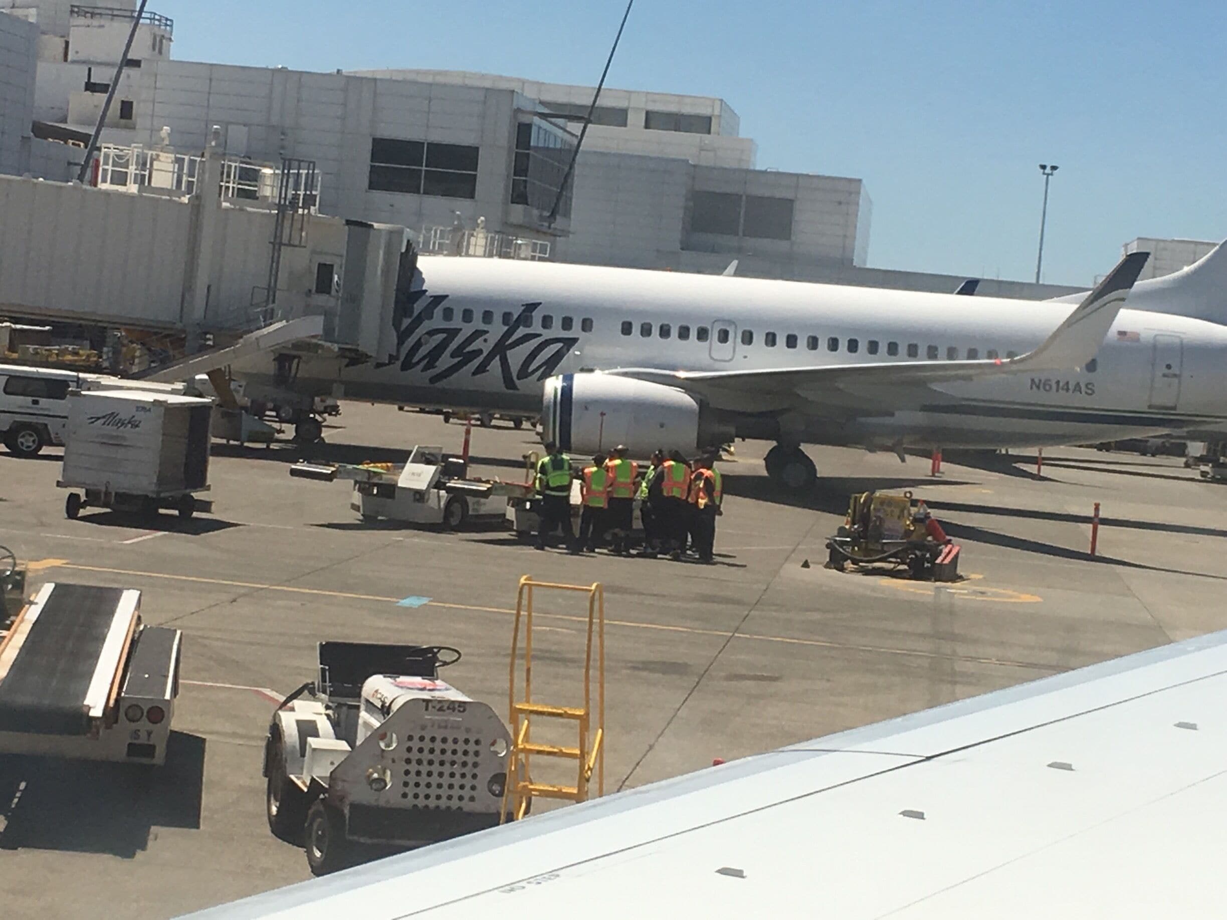 Huddle is not just in Football. Alaska Airlines ground crew Huddle before taking care of arriving planes 