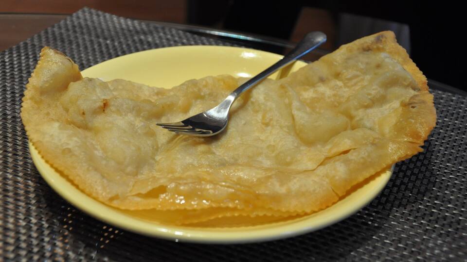 This is a cheburek. It's very thin fried dough with meat and sour cream and maybe some greens spread in the middle. I'm not a huge fan of friend dough, so I'd rather go with the shwarma offered by this little café, but I had to give cheburek a try since I'd never heard of it before! This tiny café has a small bar and a handful of tables with bench seats and chairs tucked into its corner location. Or, you can get your food to go.
