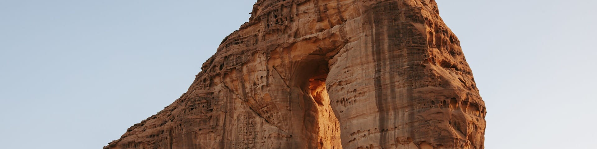 A large rock formation with a natural arch.