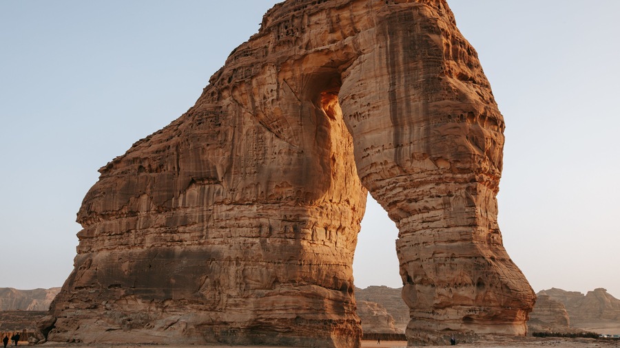 A large rock formation with a natural arch.