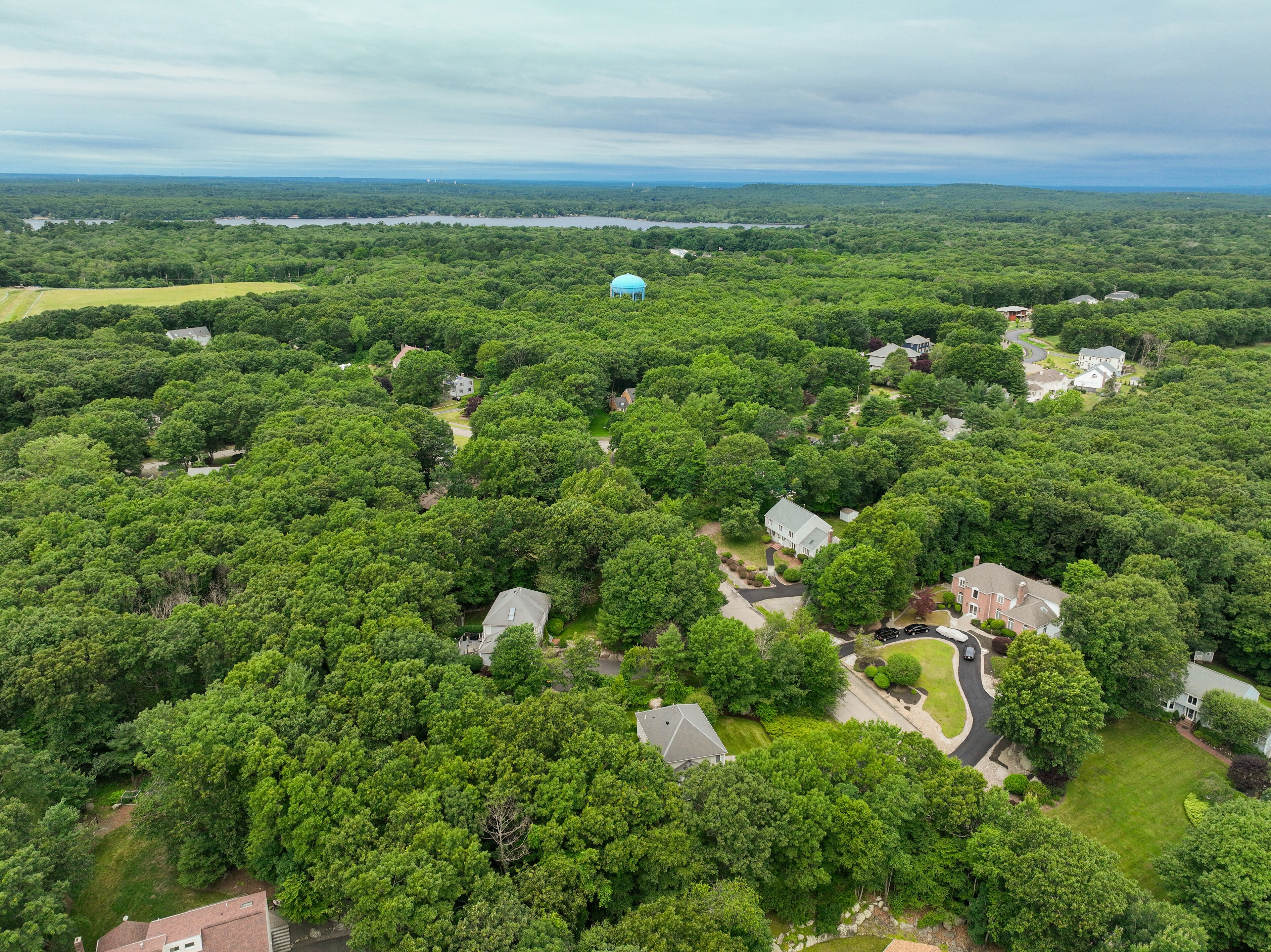 Aerial view of Suburban neighborhood in Sharon, Norfolk County, Massachusetts, with green forest and big villa.