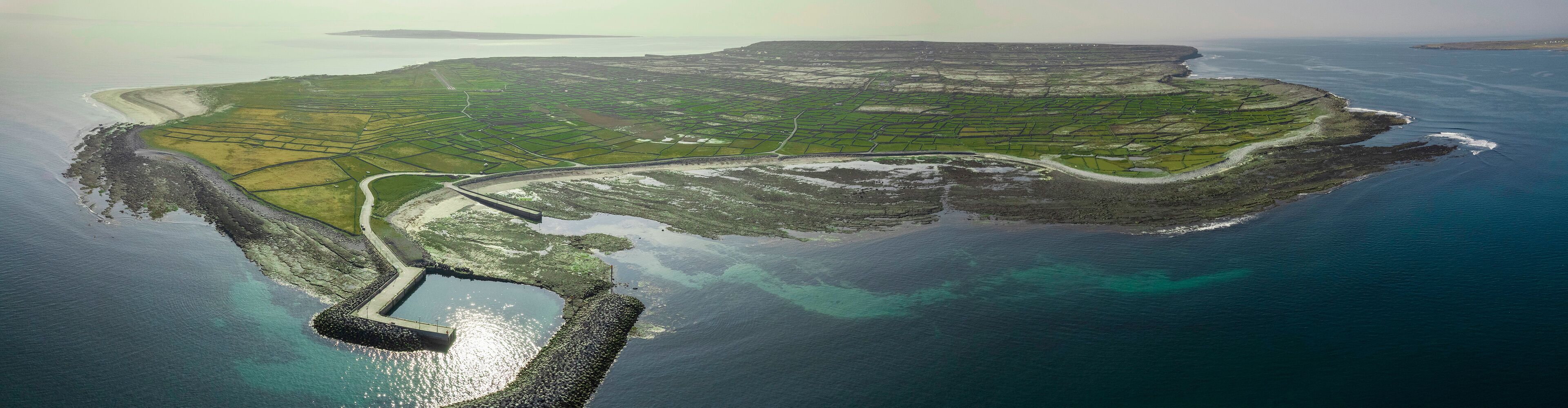 Aerial view on a Inishmaan island, Aran island, county Galway, Ireland. Popular travel destination and tourist area. Panorama image. Irish landscape with green grass fields and stone walls.