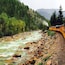 The Silverton to Durango narrow gauge railway cuts through the mountains in Colorado, giving a great view of the forest and river.