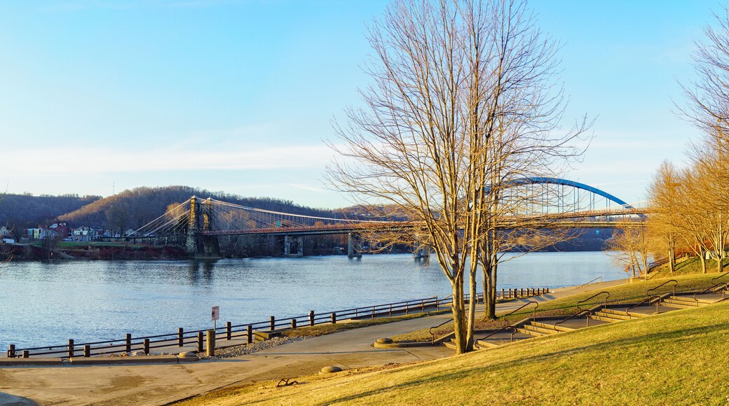 Panoramic view of the Ohio River with the landmark 1856 Wheeling Suspension Bridge and the 1955 Fort Henry Bridge, seen from Heritage Port waterfront park, Wheeling, West Virginia. January 2022.
