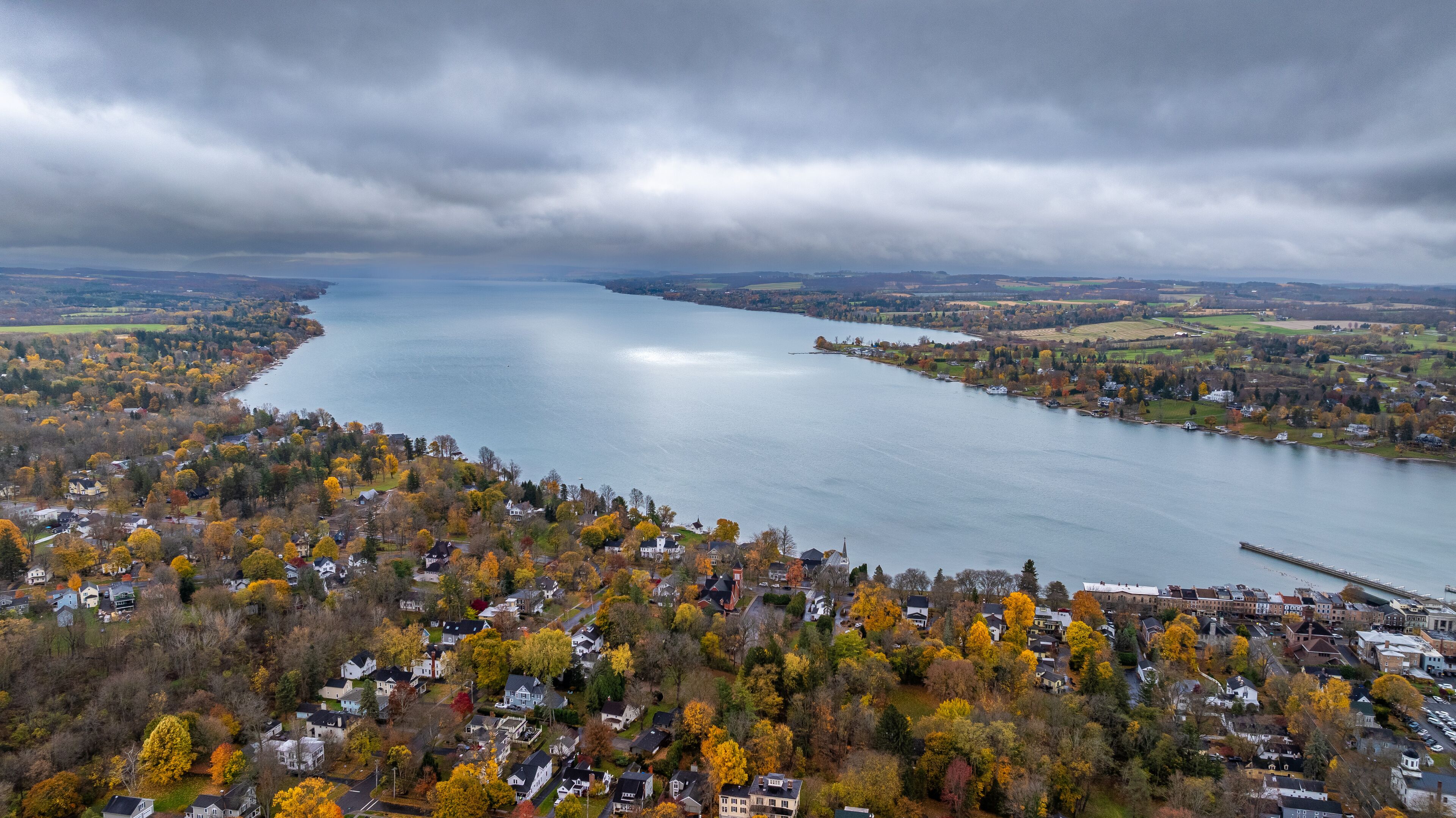 Aerial photo of fall foliage surrounding the Town of Skaneateles, Skaneateles Lake, Onondaga County, New York State, November 2024.	