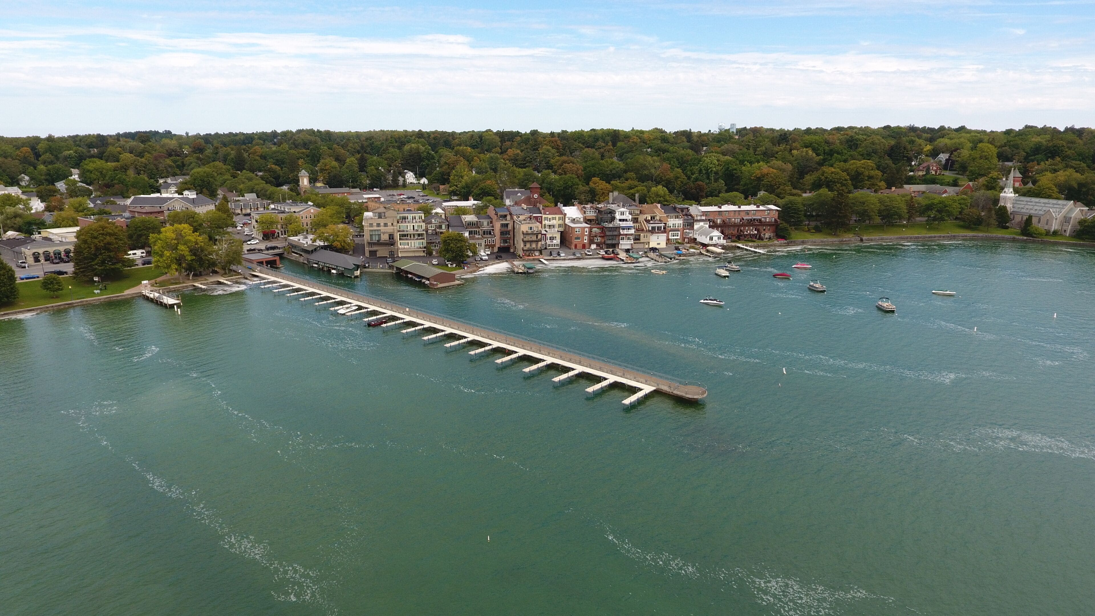 A river with a bridge, boats, and buildings along the shore.
