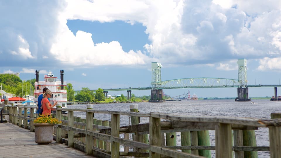 Wilmington featuring a river or creek and a bridge as well as a couple