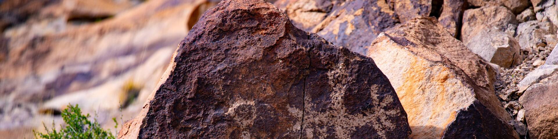 Ancient Native American Petroglyphs etched on boulder in Sloan Canyon National Conservation Area, Nevada