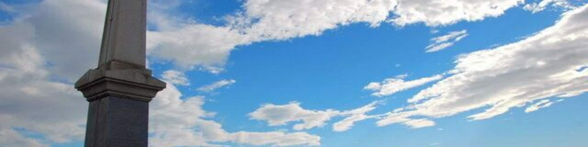 Monument, near Bridgend, Islay. The inscription reads:- John Francis Campbell, of Islay, an eminent Celtic scholar linguist scientist & traveller, a true and patriotic highlander, loved alike by peer and peasant, by his, popular tales of the west Highlands, "Leabhar na Feinne", and other literary works, he preserved and rendered classic the, folk-lore of the Scottish Highlands. He lies buried at Cannes in France, his memory lives in the hearts of his countrymen. Born 1821 Died 1885