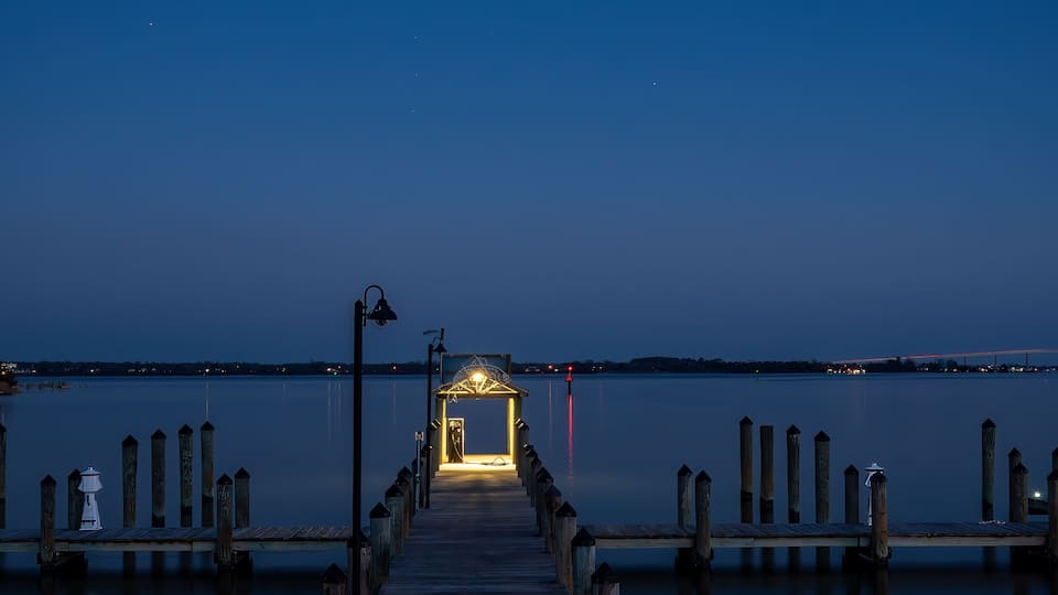 Solomons, Maryland, USA An illuminated pier at night on the Patuxent River.