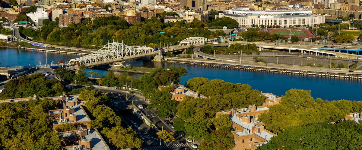 Aerial View of Yankee Stadium, Macombs Dam Bridge & the Harlem River on a sunny day.