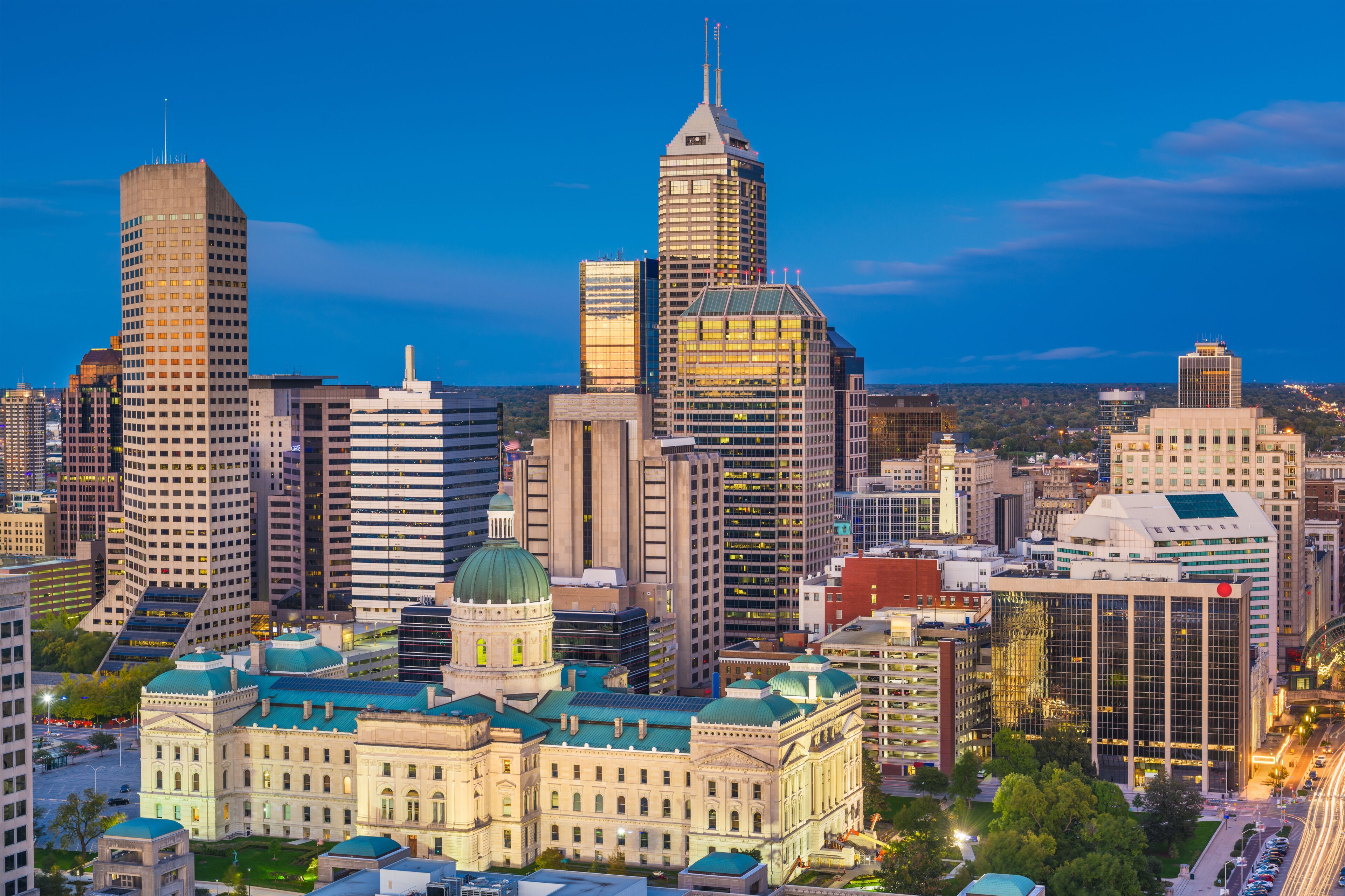 Indianapolis, Indiana, USA downtown city skyline with the State House at dusk.