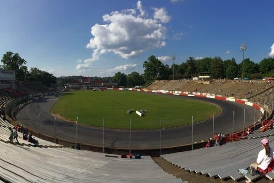 A large stadium with tiered seating and a grassy field.