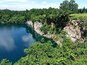 For years this rain-filled granite quarry sat in the city center unbeknownst to the locals. Now the city has spent millions developing public park around it, including observation platform that extends over the water.