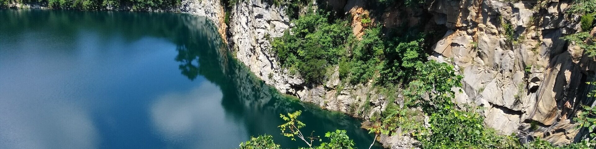 For years this rain-filled granite quarry sat in the city center unbeknownst to the locals. Now the city has spent millions developing public park around it, including observation platform that extends over the water.