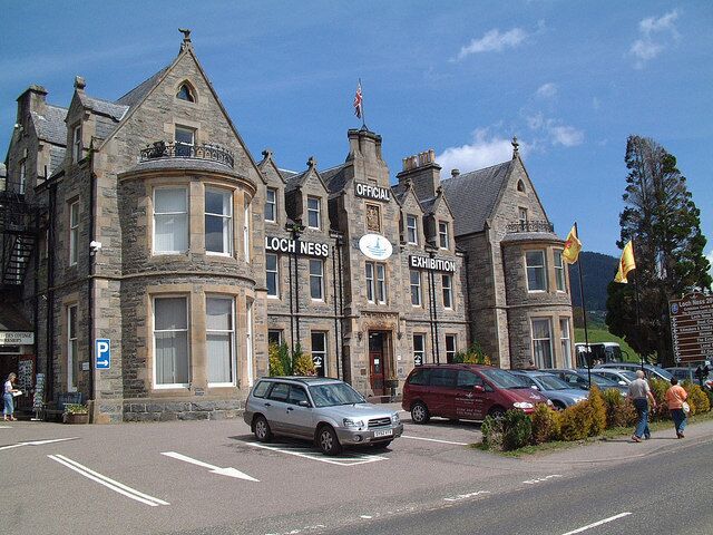 A historic building with a sign reading "Loch Ness Exhibition".