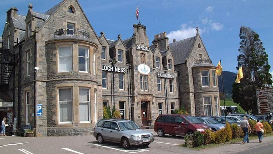 A historic building with a sign reading "Loch Ness Exhibition".