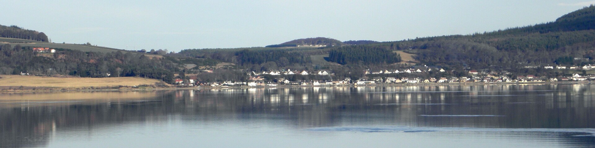 Hay rolls and the Beauly Firth This is a view over Bunchrew (Bun Chraoibh ) Bay and Beauly Firth (Linne Fharair, Poll an Ròid or Caolas Uisge a' Mhanachainn ) towards Redcastle on the Black Isle (an t-Eilean Dubh )