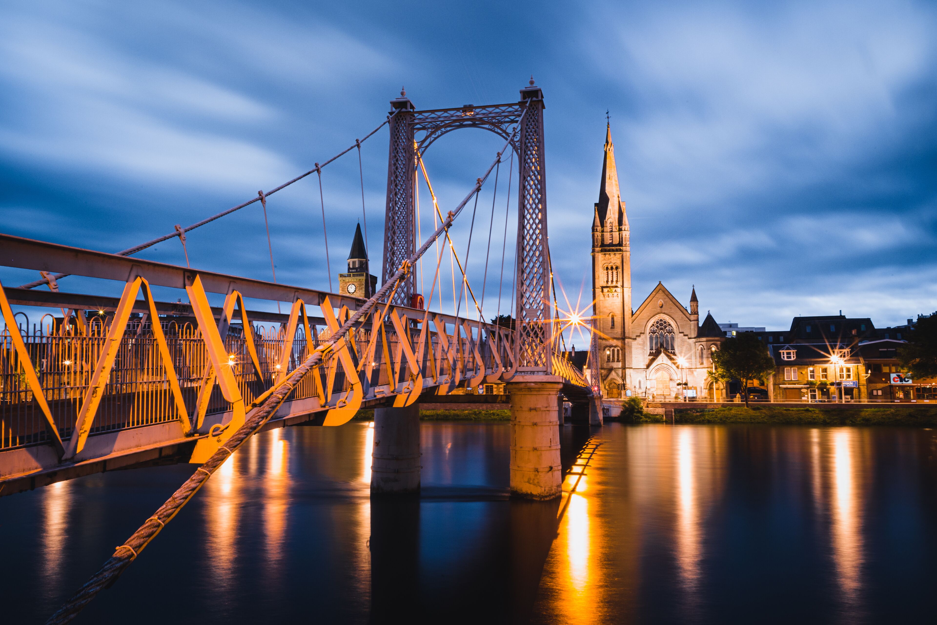 A bridge with a gothic church in the background.