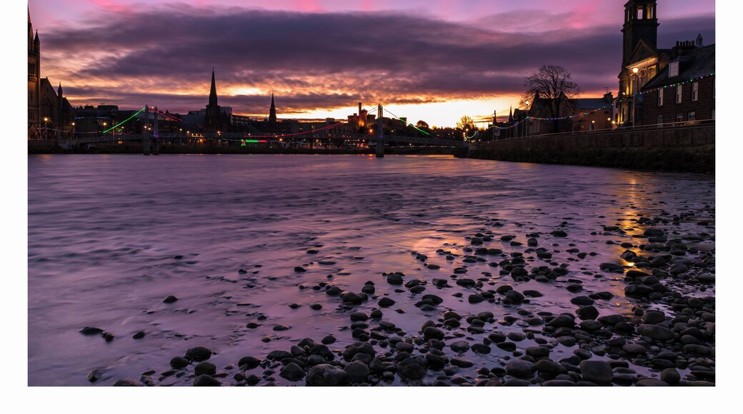 a bright light announcing the sunrise over the river Ness