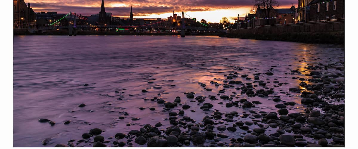 a bright light announcing the sunrise over the river Ness