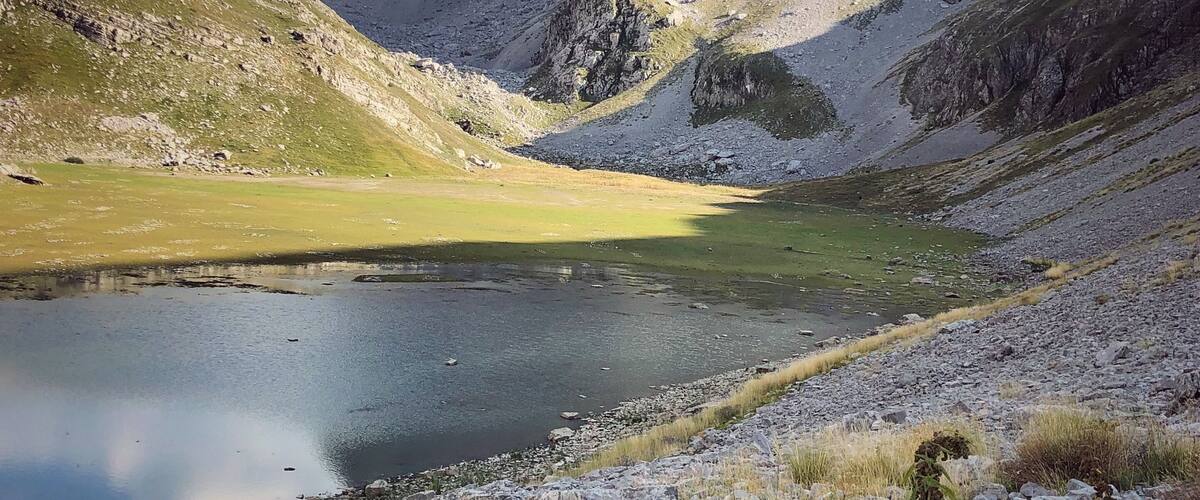 A mountainous landscape with a lake and rocky terrain.