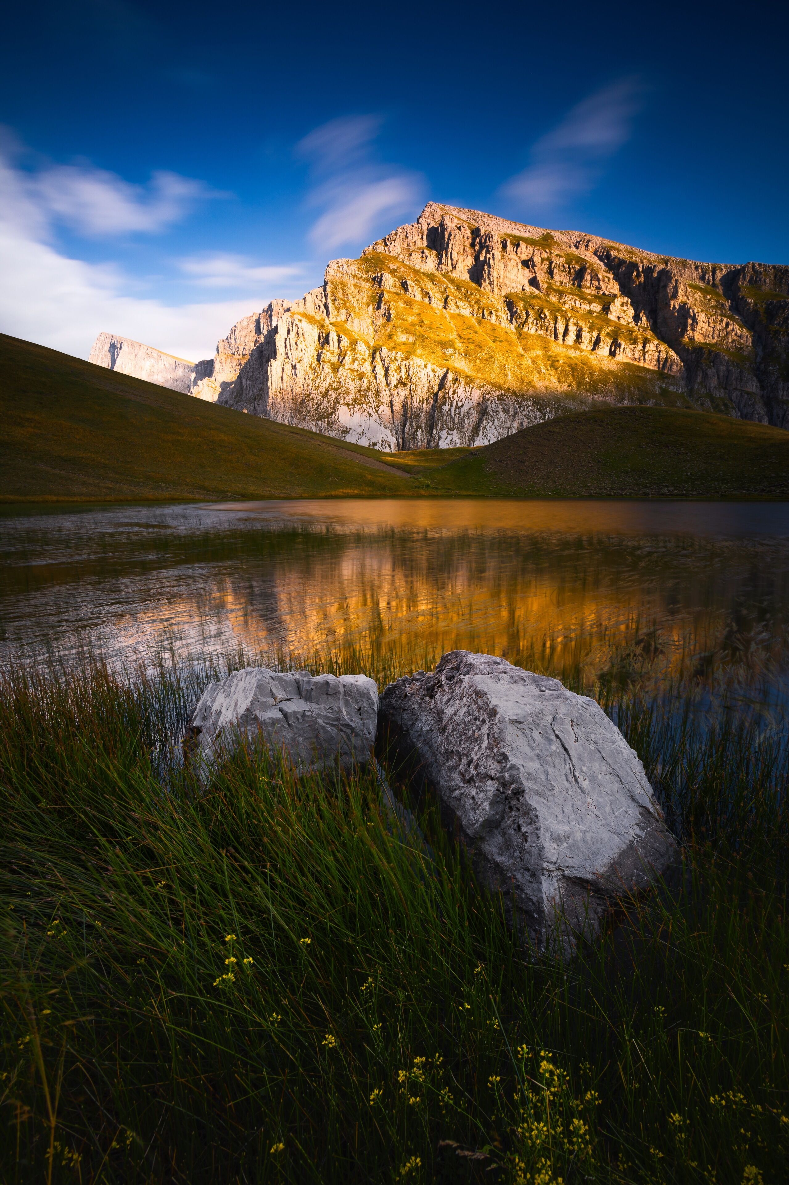 Golden sunlight hitting the peaks above the dragon lake in northern Greece. It's a moderately steep hike of about 3 hours to the refuge (where you can sleep and order food) and then another hour to this lake. We had the place to ourselves the entire evening. It was magical! #golden
