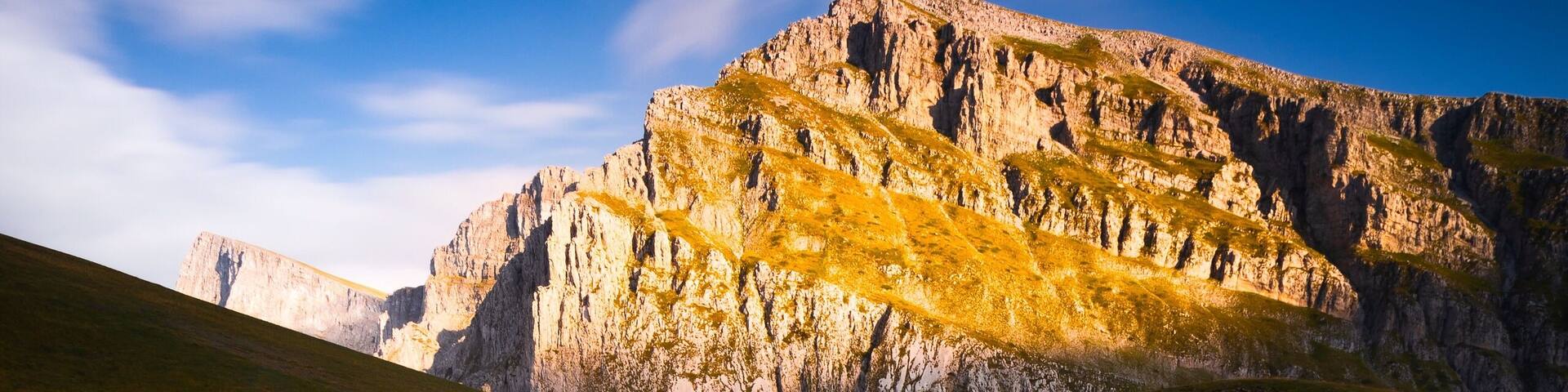 Golden sunlight hitting the peaks above the dragon lake in northern Greece. It's a moderately steep hike of about 3 hours to the refuge (where you can sleep and order food) and then another hour to this lake. We had the place to ourselves the entire evening. It was magical! #golden