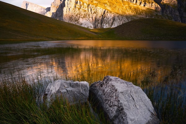 Golden sunlight hitting the peaks above the dragon lake in northern Greece. It's a moderately steep hike of about 3 hours to the refuge (where you can sleep and order food) and then another hour to this lake. We had the place to ourselves the entire evening. It was magical! #golden